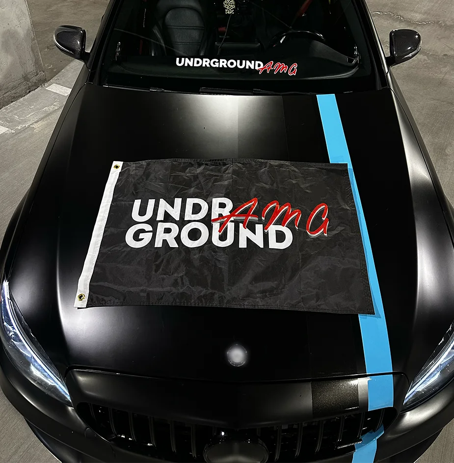 UA flag held beside a C43 AMG